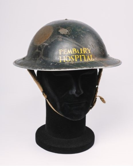 Image shows a metal hat with signs of corrosion. In yellow lettering on the front are the words 'Pembury Hospital'